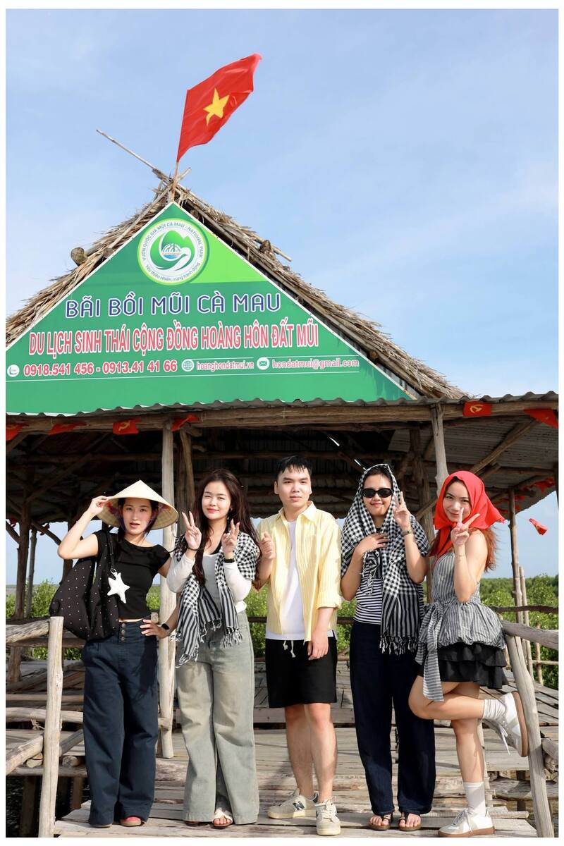 Đoàn du khách check-in trên cầu gỗ hướng ra bãi bồi Đất Mũi